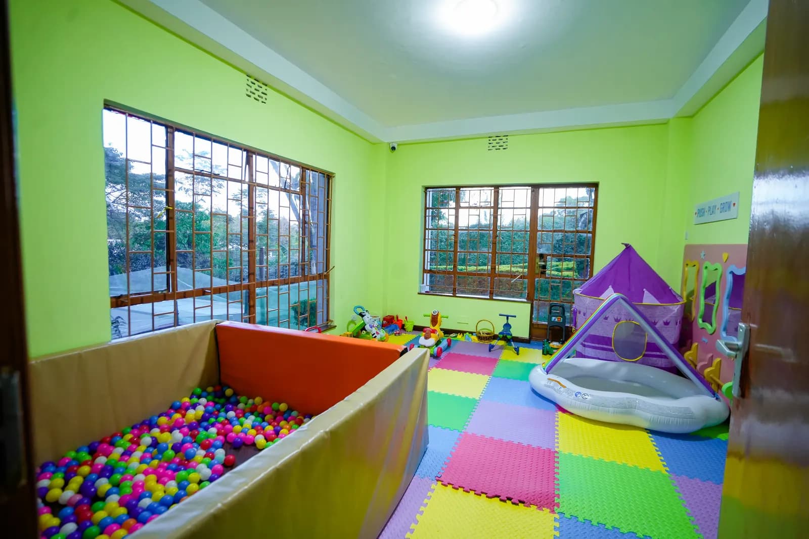 The soft-play room at Daydreams, with a ball pit, a purple play tent and bright foam floor tiles