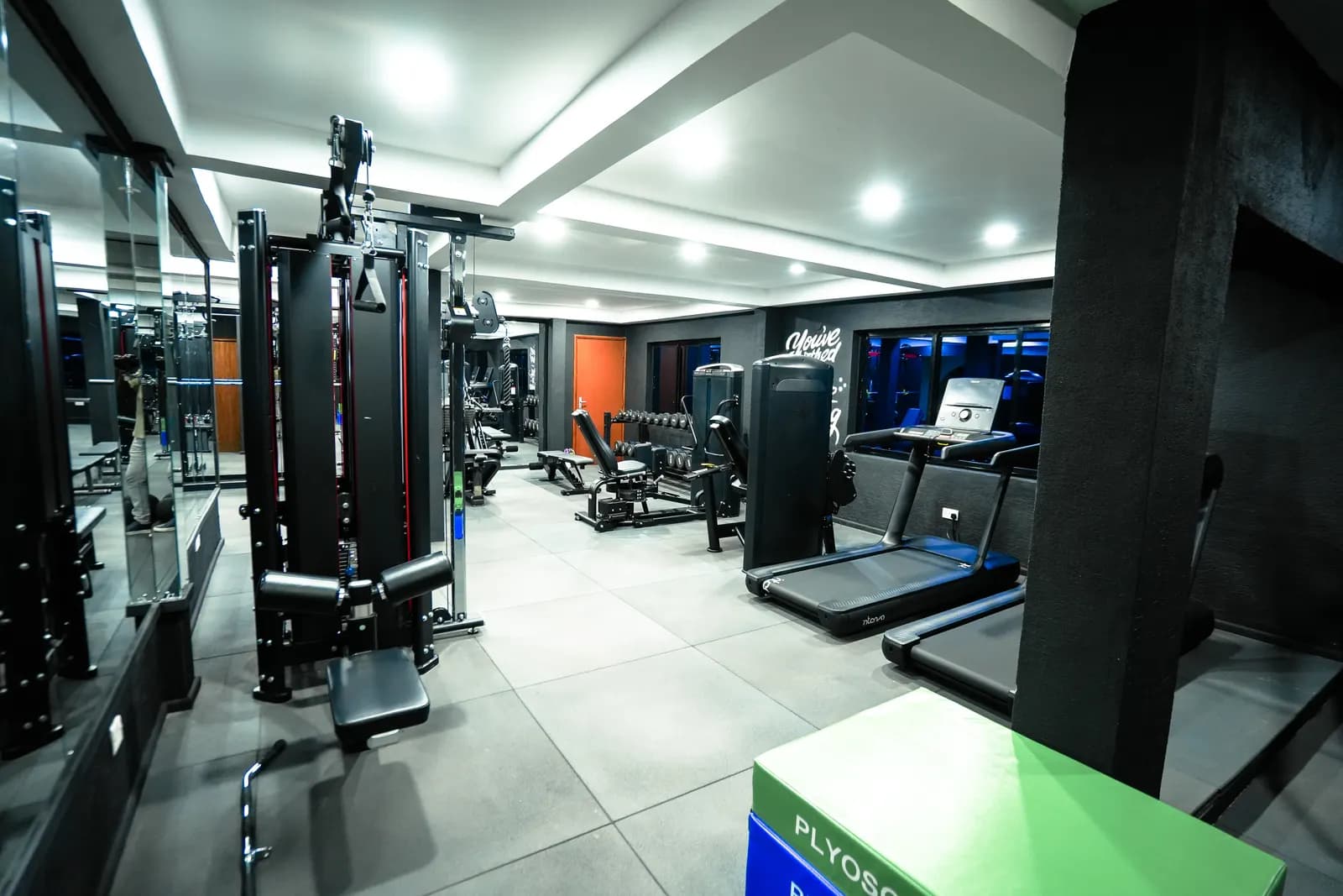 Cable machines, a squat rack and treadmills at Dumbbells gym