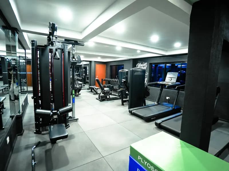 Cable machines, a squat rack and treadmills on the Dumbbells gym floor